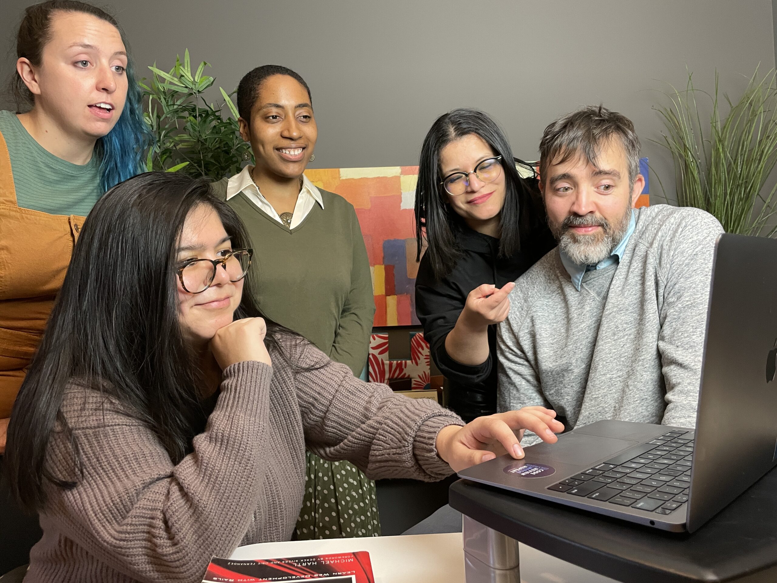 Coders looking at a screen together.