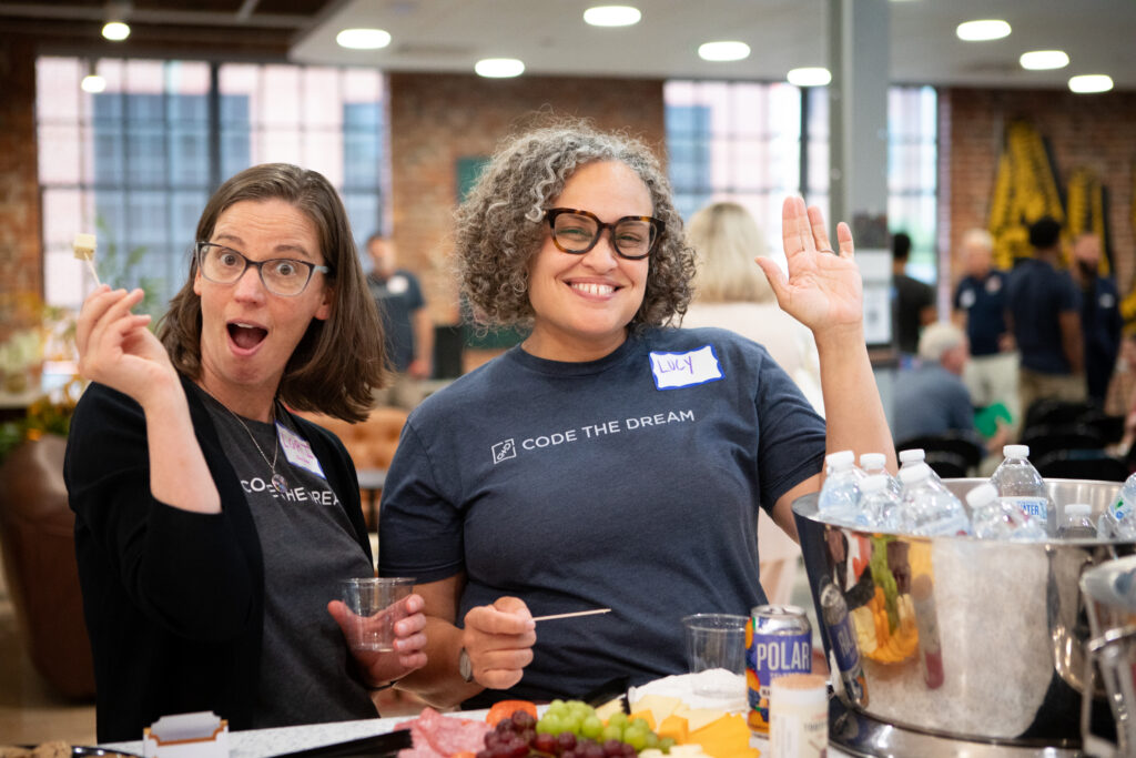 Lori Fernald Khamala and Lucy Martinez making goofy faces for the camera at the Juneteenth event